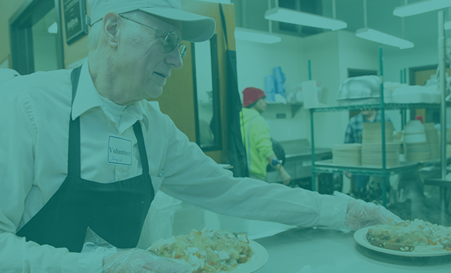 Happy volunteer serving plates of food