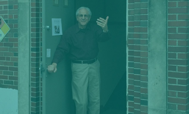 Joe gestures person to come inside the door of Shelter KC