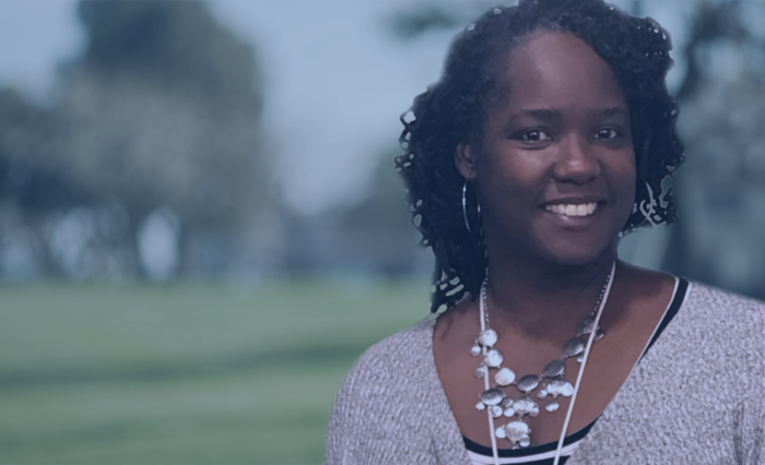 Smiling woman in front of blurred park background