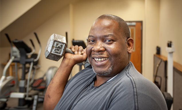 Smiling man works out in gym