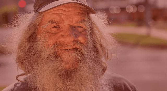 Close up of smiling man with large beard and baseball cap