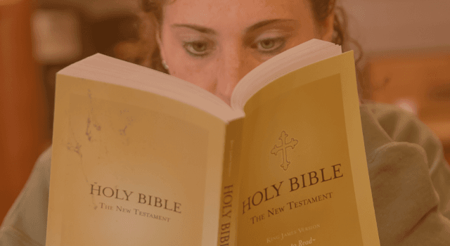 Woman intently reading the Holy Bible